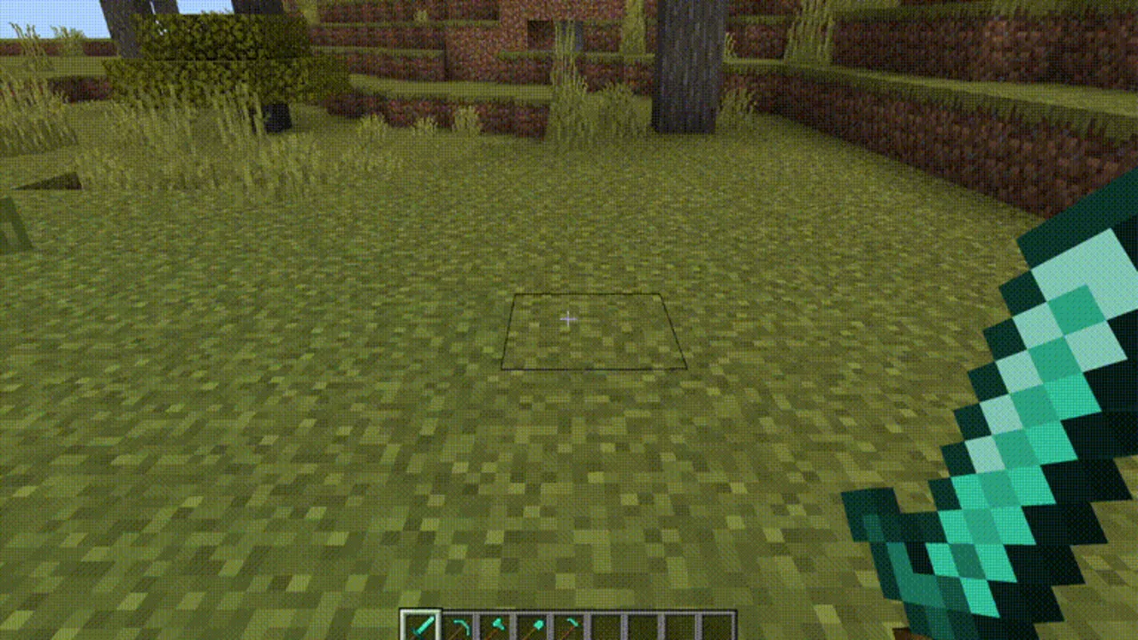 Blurry's Java PvP addon: Player holding diamond sword in grassy area