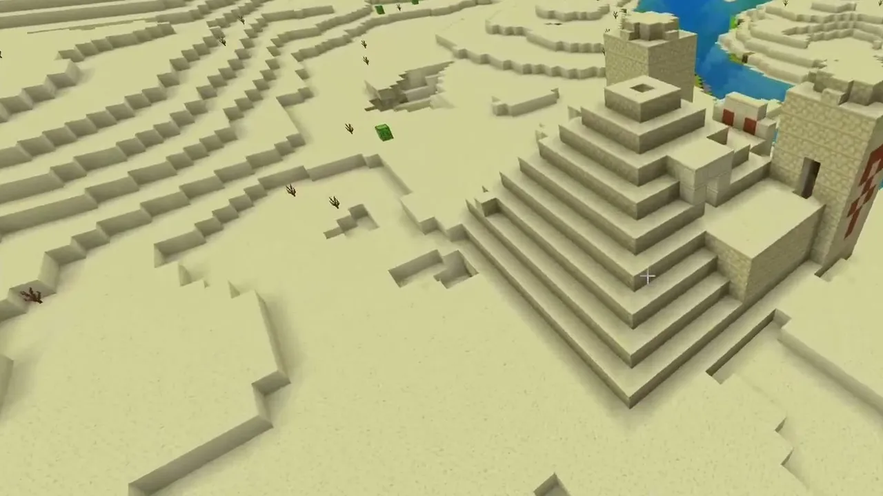 River Bay Village and Temple: closer view of a desert temple built into a sandy hillside beside a river