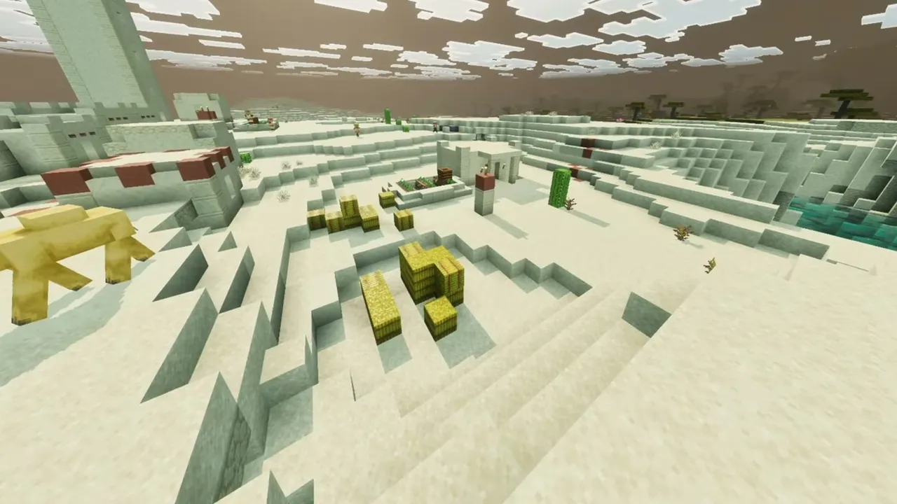 Sinkhole Desert Village: closer view of sandstone village houses, hay bales, and a camel on the sand