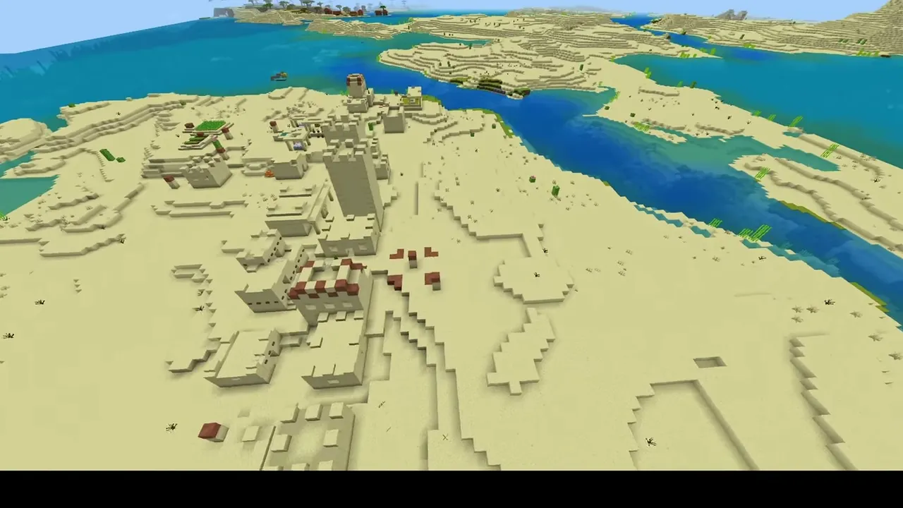 Dune Valley Village: wide aerial view of a desert village on a sandy ridge between a river and the sea